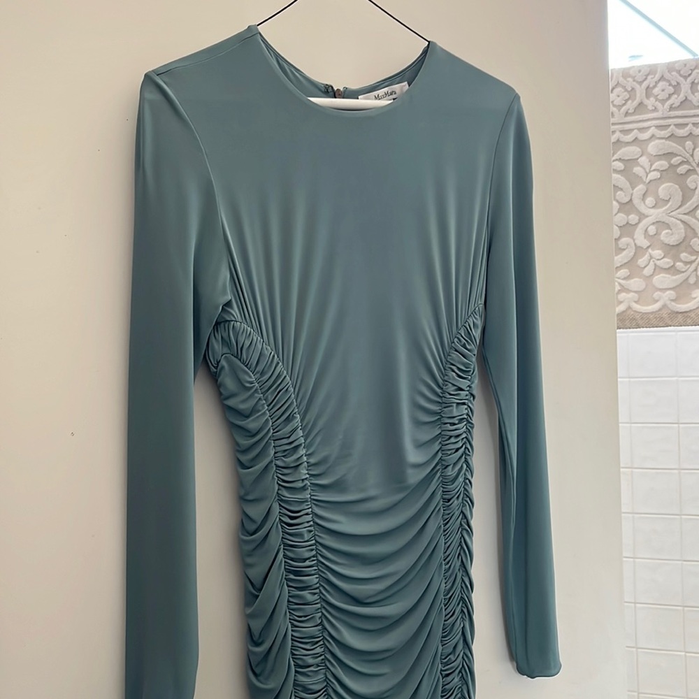 This is like a light turquoise stretch. Very soft worn once. Zipper in the back.